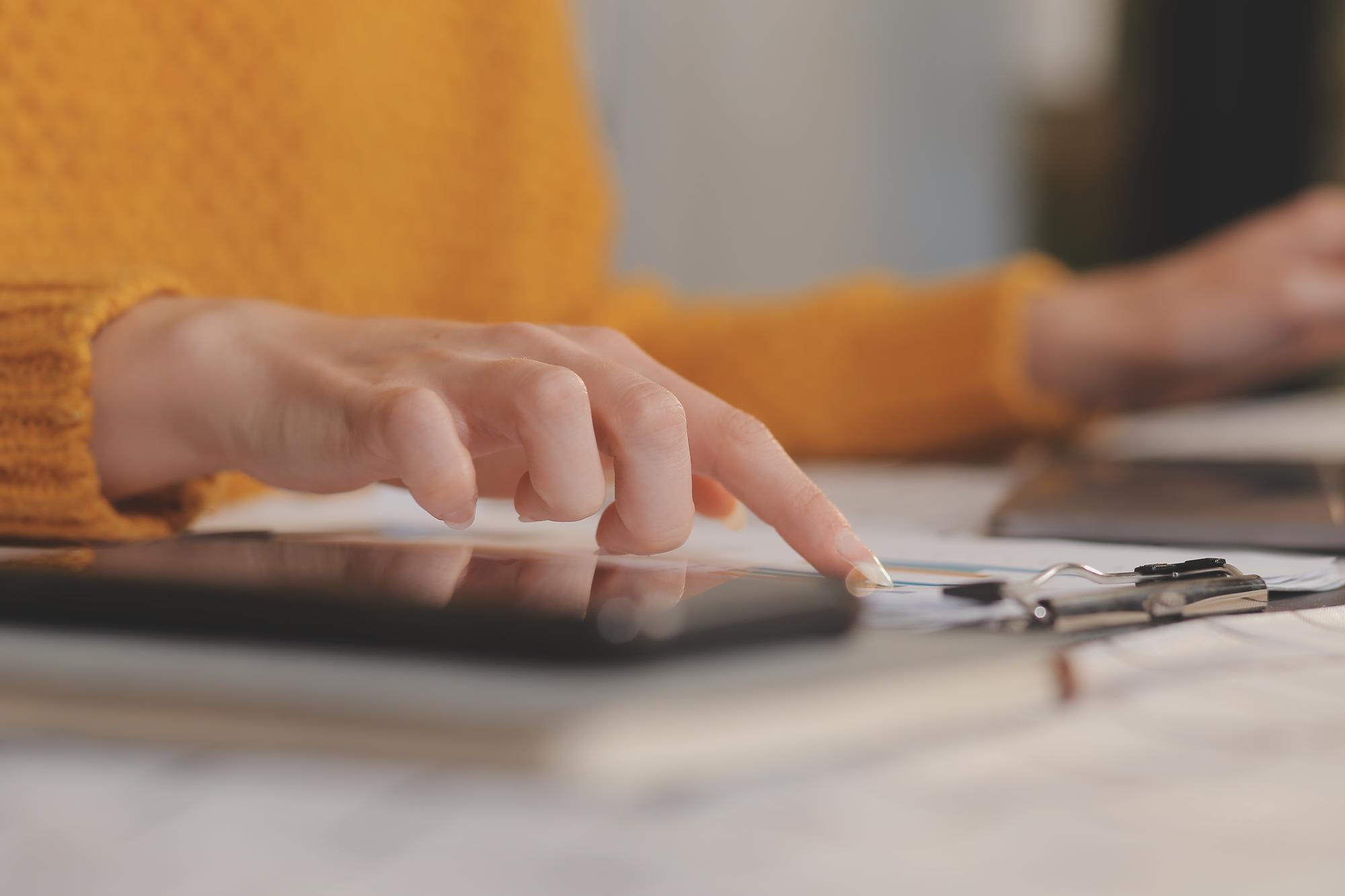 Close-up Hands with Calculator and Notes