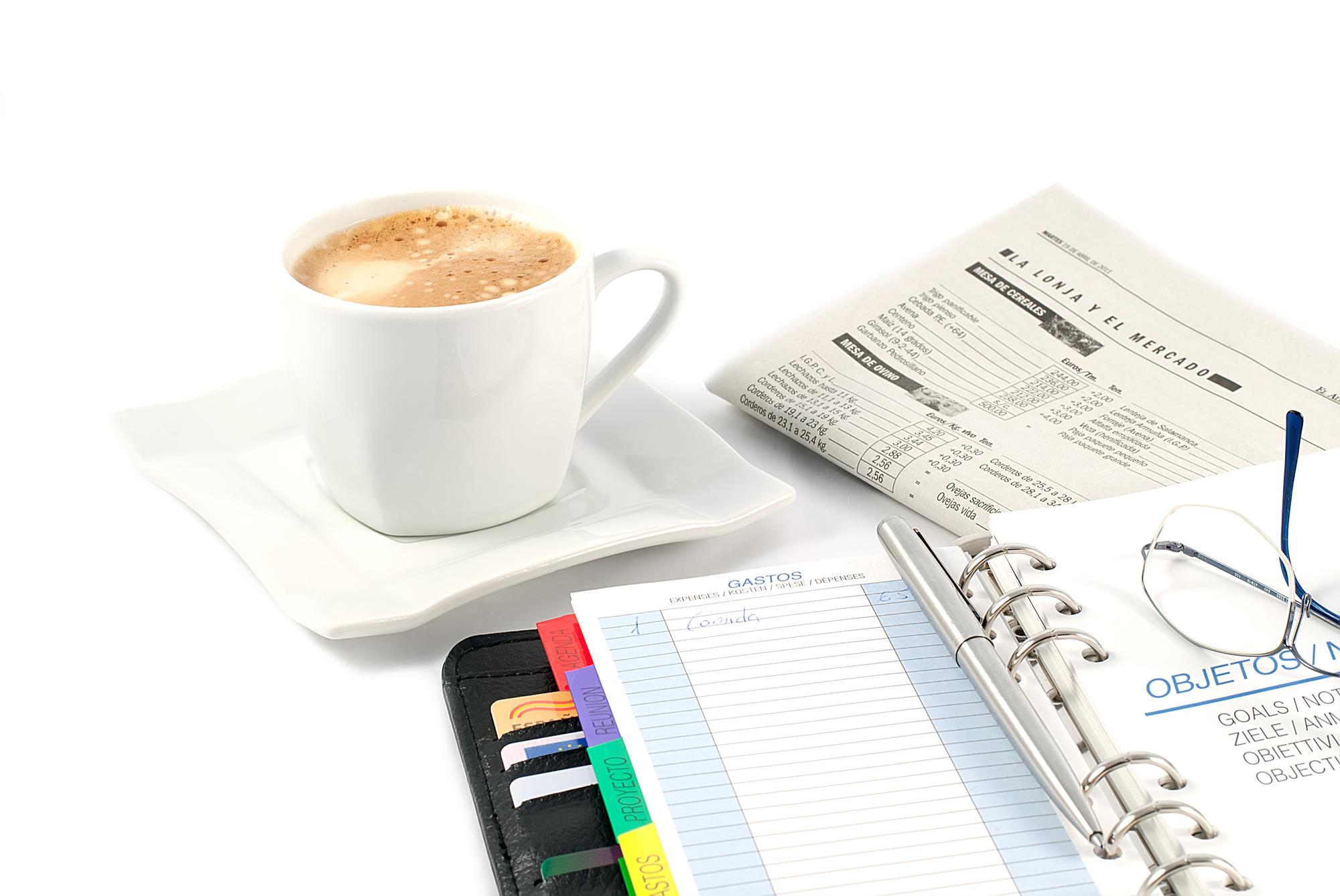 Person reviewing financial plan over coffee